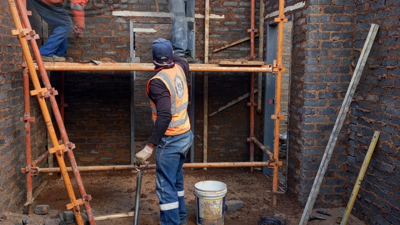 uniformed skill builders on scaffolds working on a construction project